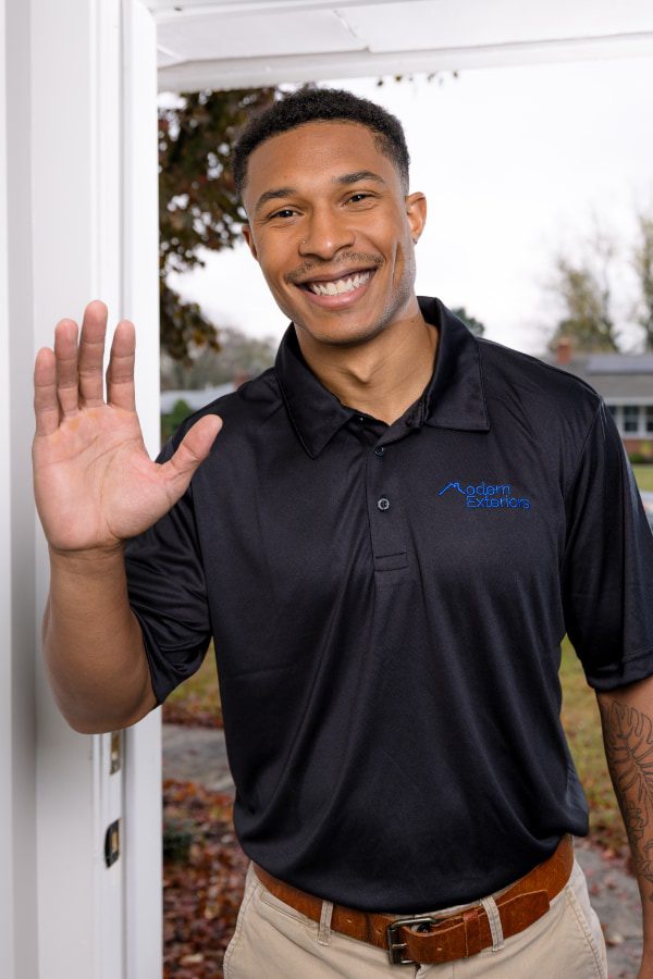 Professional roofing contractor greeting homeowner, residential roof installation and maintenance services